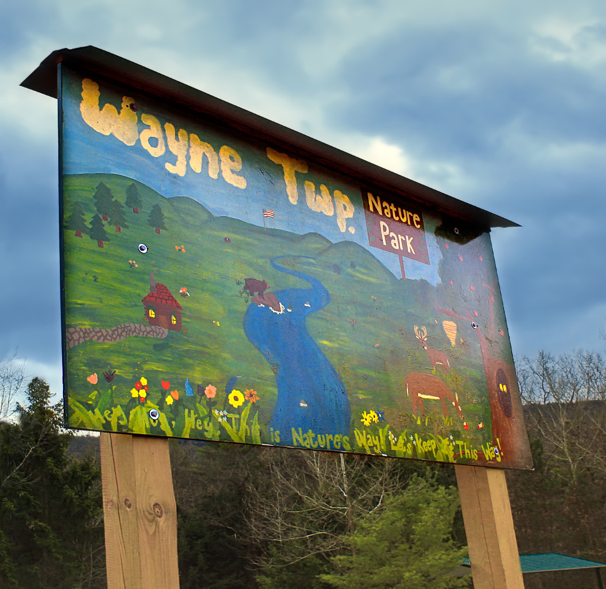 Wooden parking-area sign for Wayne Township Nature Park, with bare autumn woods behind it, near McElhattan in Clinton County, Pennsylvania