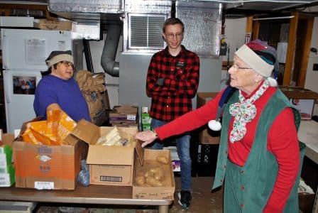 Three volunteers pack boxes and bags of food during a Wednesday distribution at St. Paul Lutheran Church Food Pantry in Mill Hall, Pennsylvania