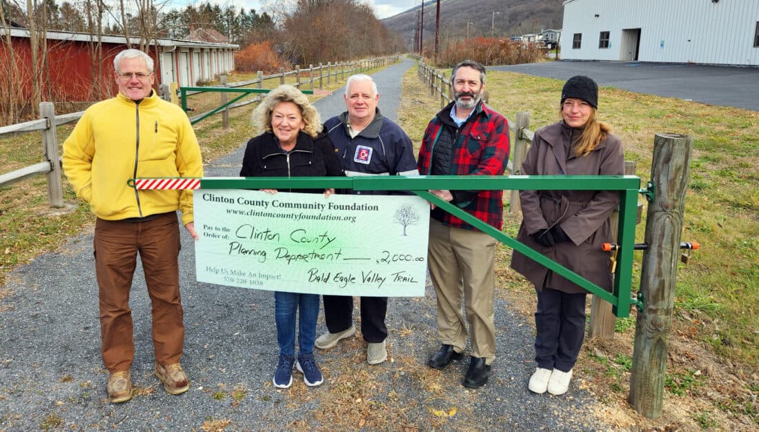 Clinton County Community Foundation and county officials stand at the new green swing gates on the Bald Eagle Valley Trail near the Castanea trailhead