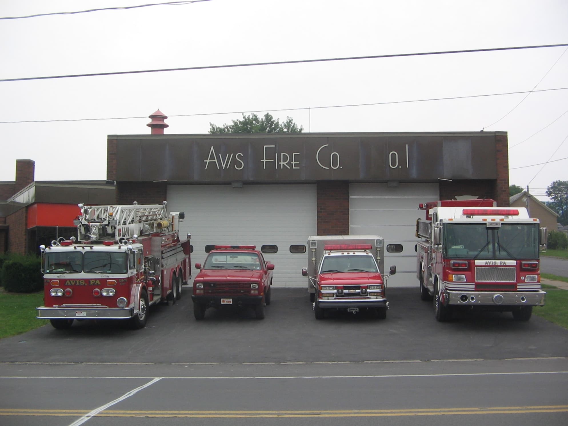 Fire engines parked outside the Avis Volunteer Fire Company No. 1 station on Central Avenue in Avis, Pennsylvania