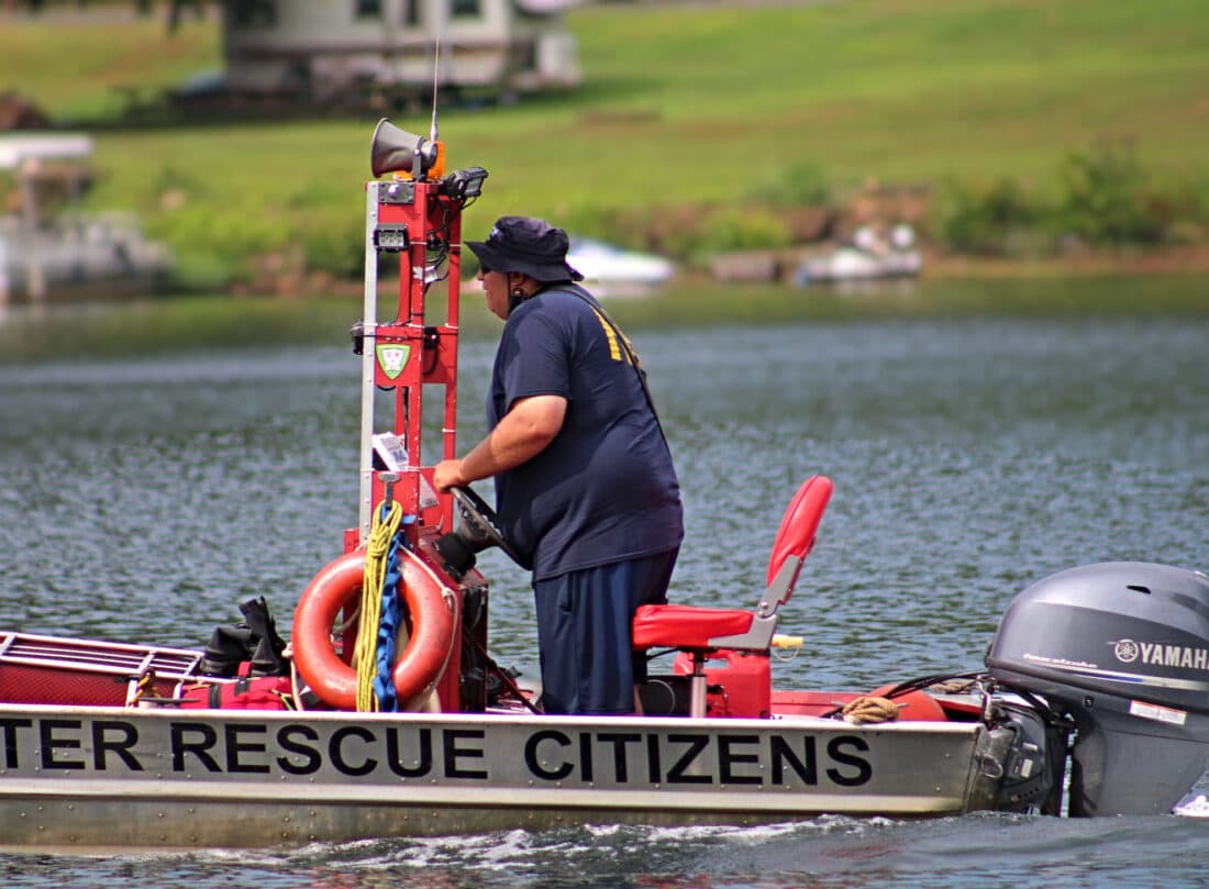 Crew member steering a Citizens Hose water rescue boat on the Susquehanna River near Lock Haven, Pennsylvania