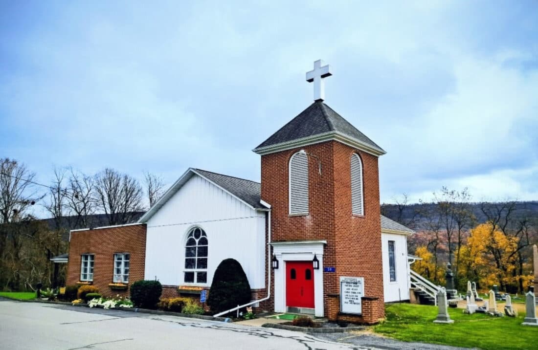The exterior of Dunnstown United Methodist Church, a white clapboard church in Dunnstown, Pennsylvania